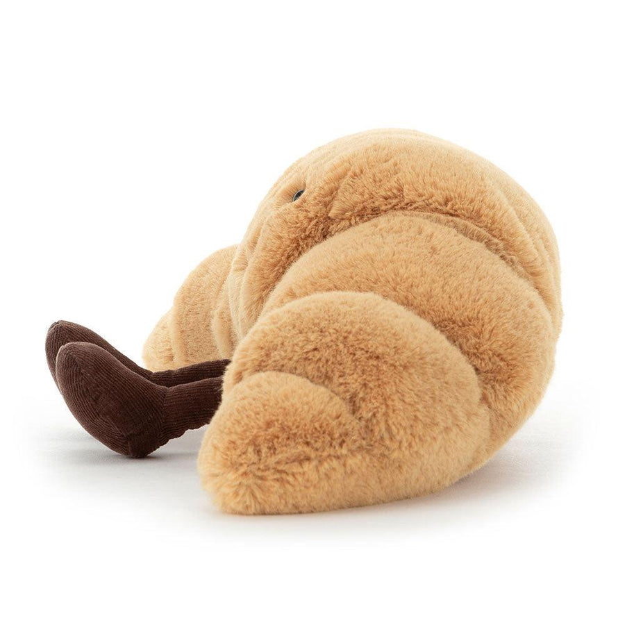 Jellycat Amuseables Croissant sett fra siden – gyllen plysj croissant med myke bein