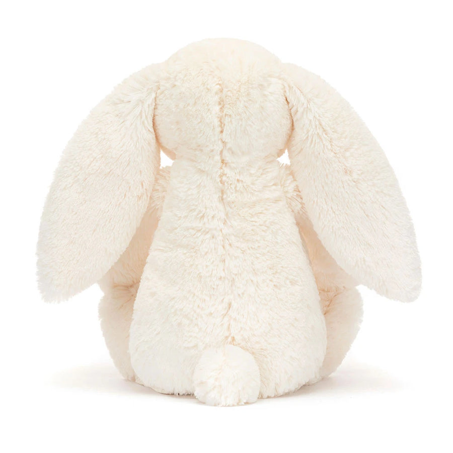 Kremfarget Jellycat-kanin med rosa jordbær- og blomstermønster